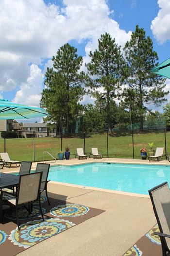 Sparkling pool with sundeck and chaise lounges